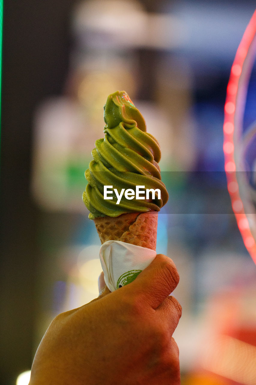 Close-up of hand holding ice cream cone