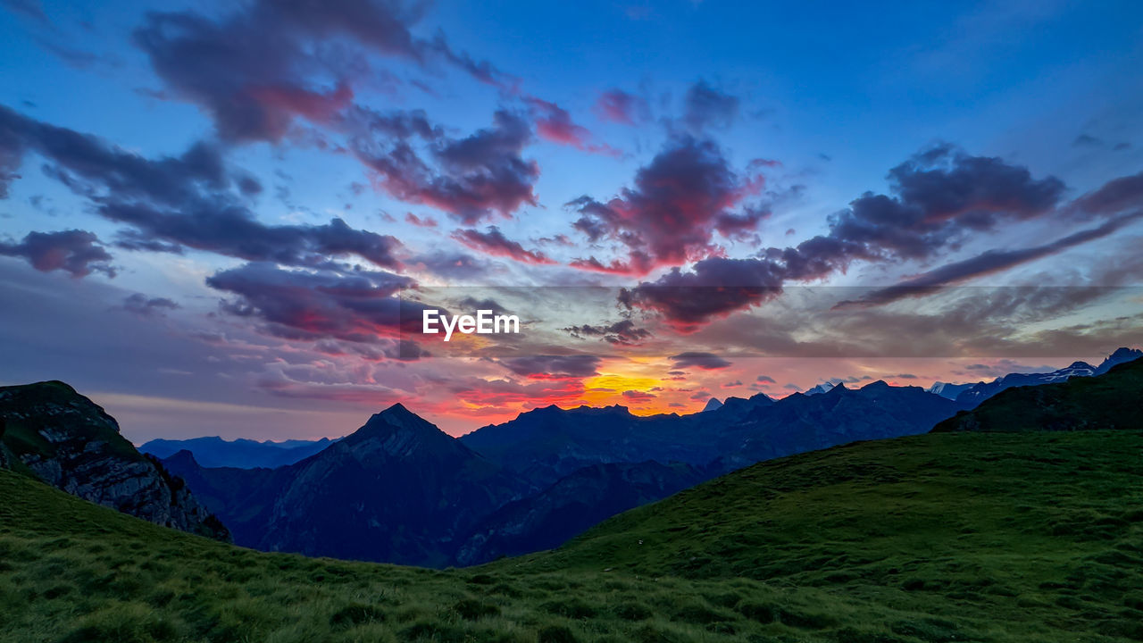 Scenic view of mountains against sky during sunrise