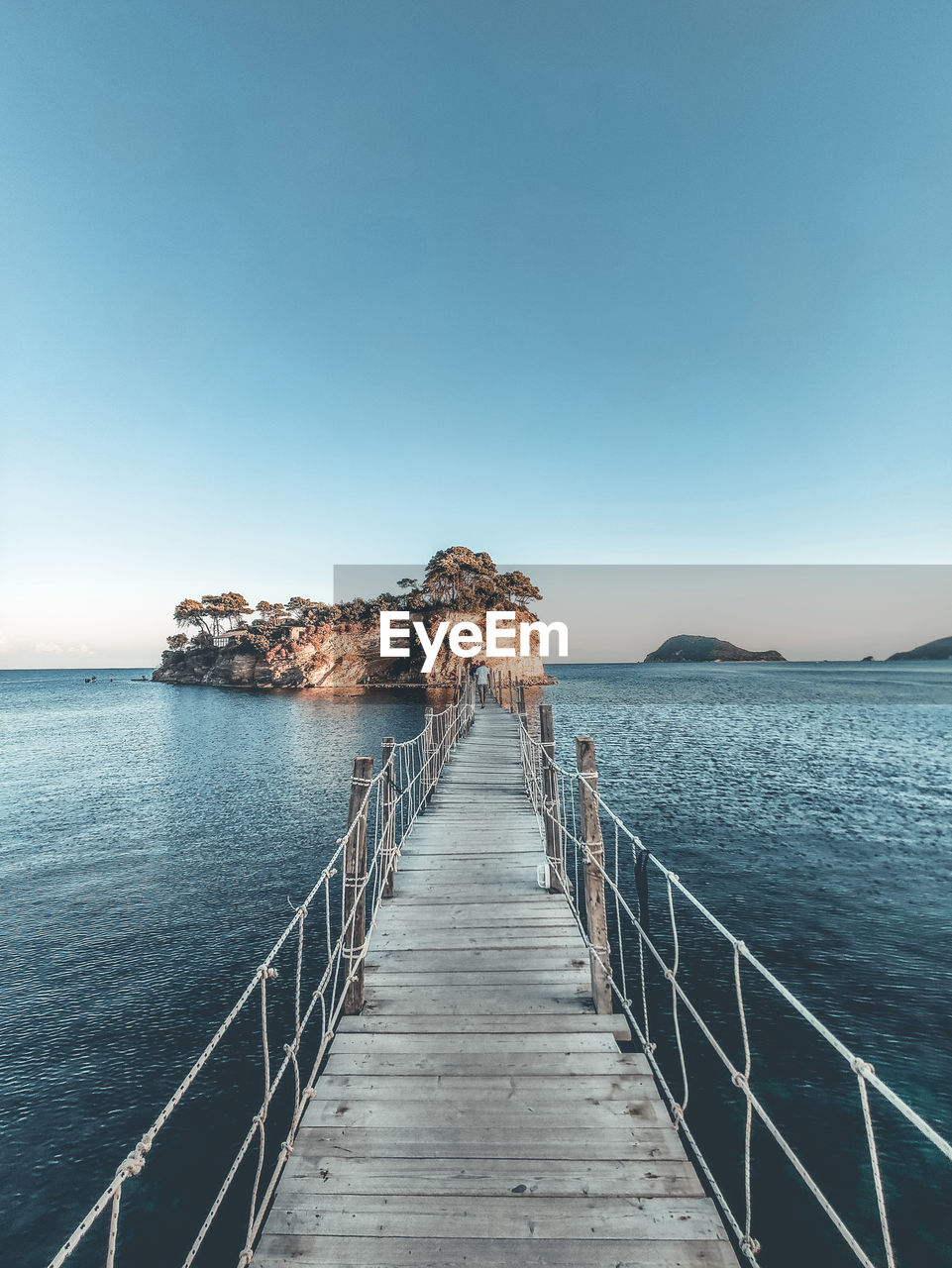 Pier over sea against clear sky