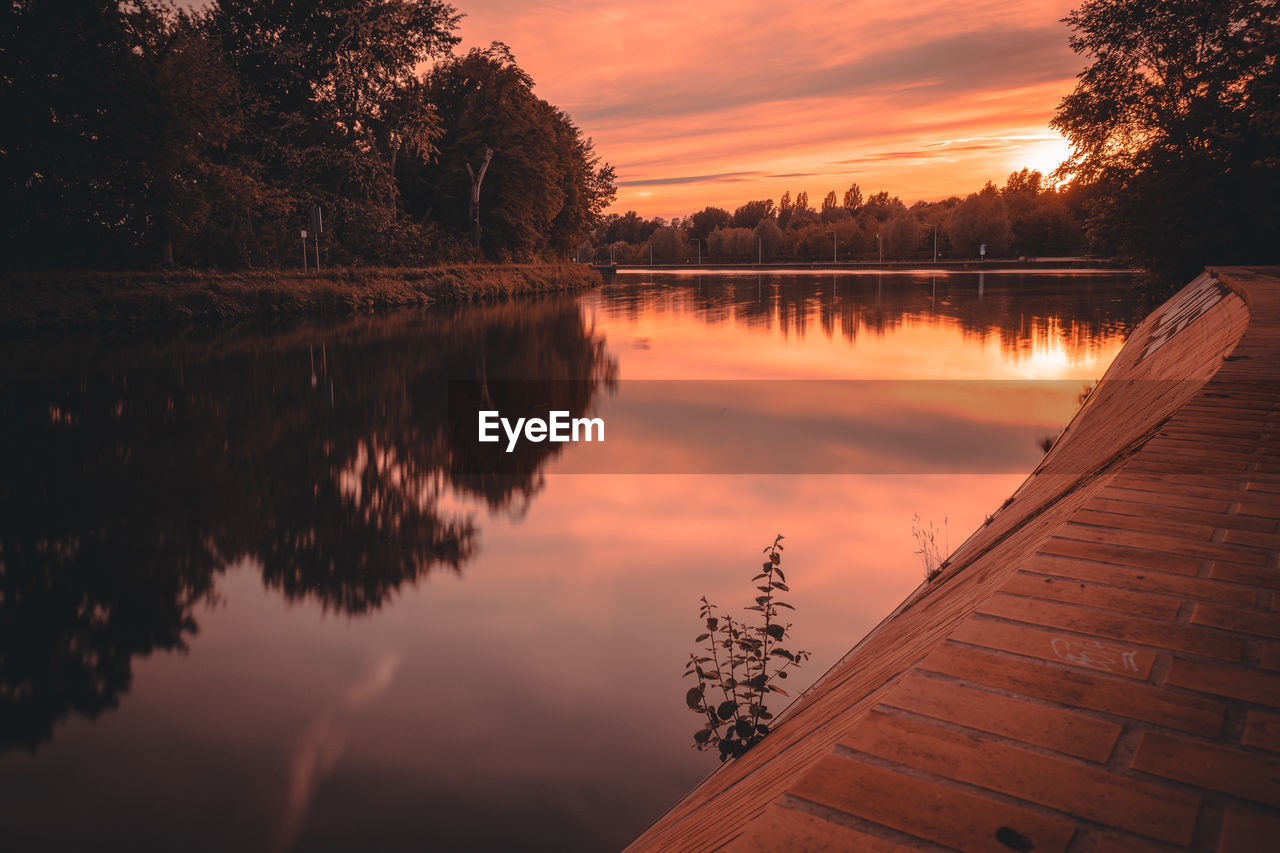 Scenic view of lake against sky during sunset