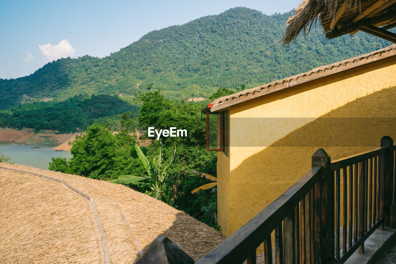 architecture, nature, mountain, vacation, built structure, plant, tree, building exterior, building, estate, water, sky, no people, house, scenics - nature, day, rural area, railing, beauty in nature, outdoors, land, travel destinations, sunlight, mountain range, wall, residential district, tranquility, travel, landscape, environment, tropical climate, tranquil scene, tourism, roof