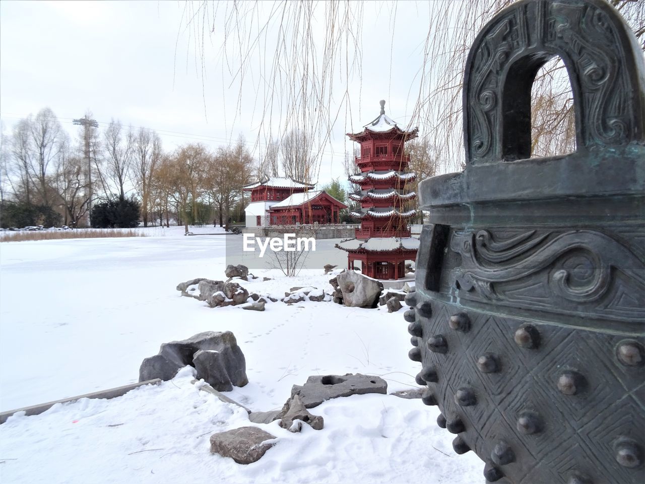 SNOW COVERED LAND AND BUILDINGS AGAINST SKY