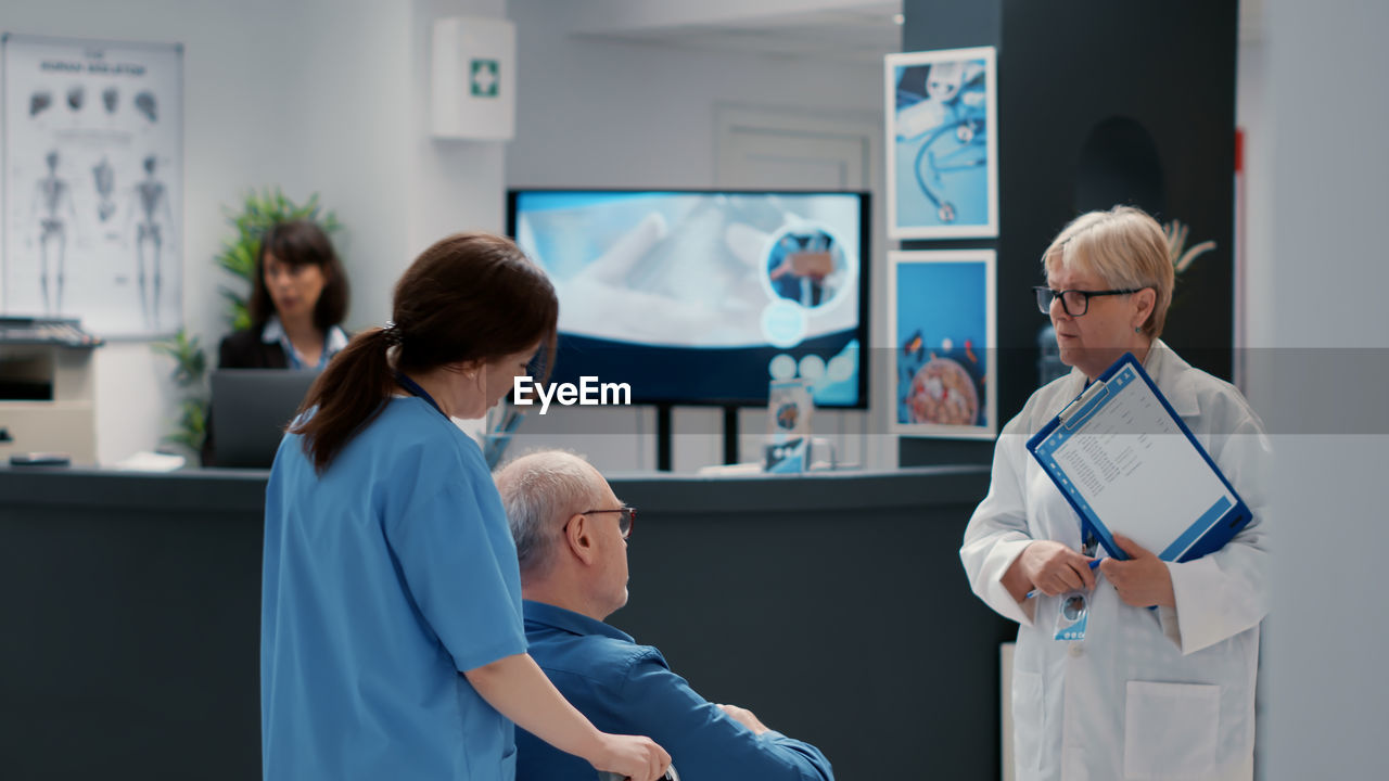 Doctor talking with patient at hospital