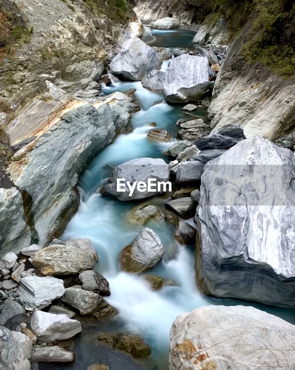STREAM FLOWING THROUGH ROCKS