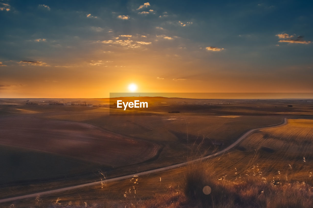 Scenic view of landscape against sky during sunset