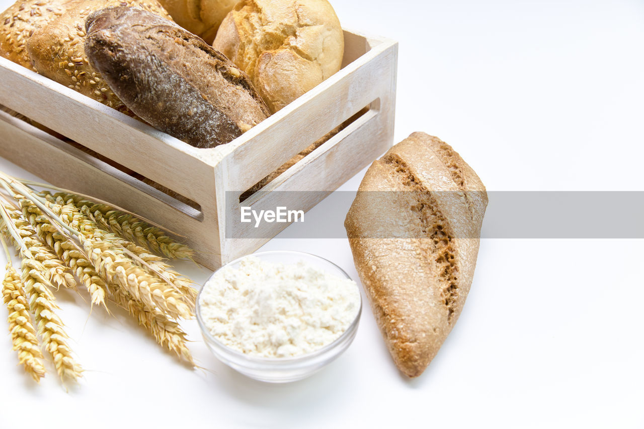 Delicious breads next to the spikes on a white background.