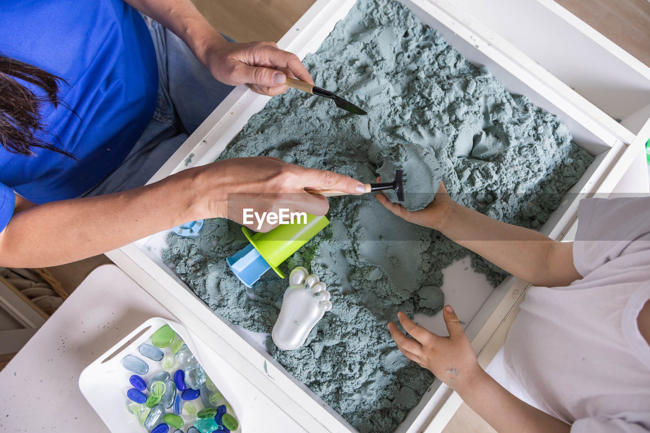 high angle view of woman painting on table