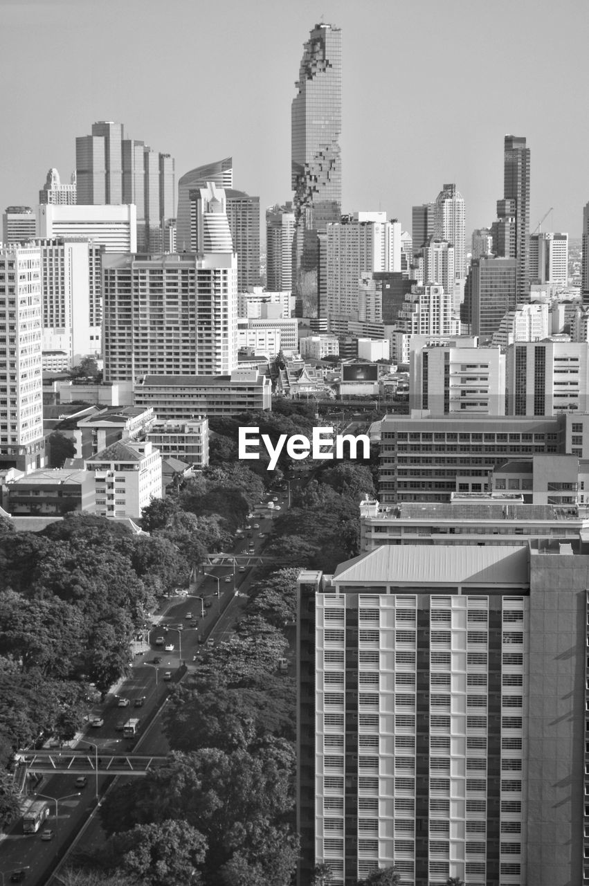 Buildings in city against clear sky