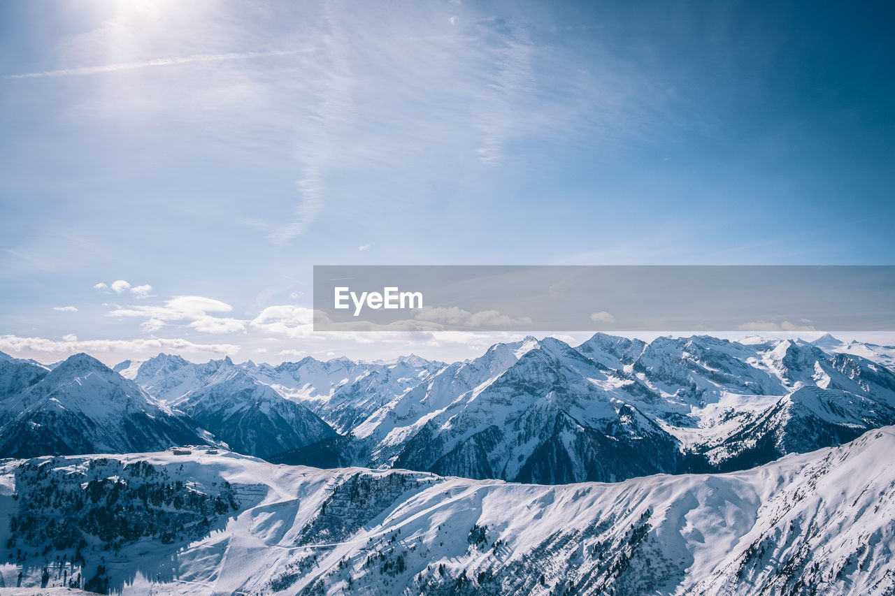 Scenic view of mountains against blue sky