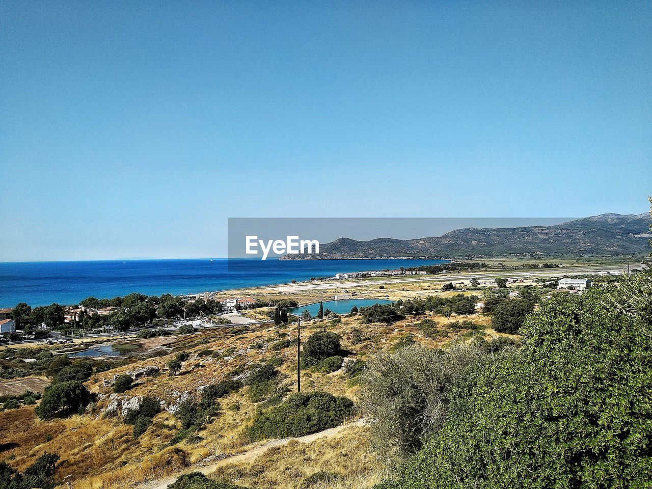 Scenic view of sea against clear blue sky