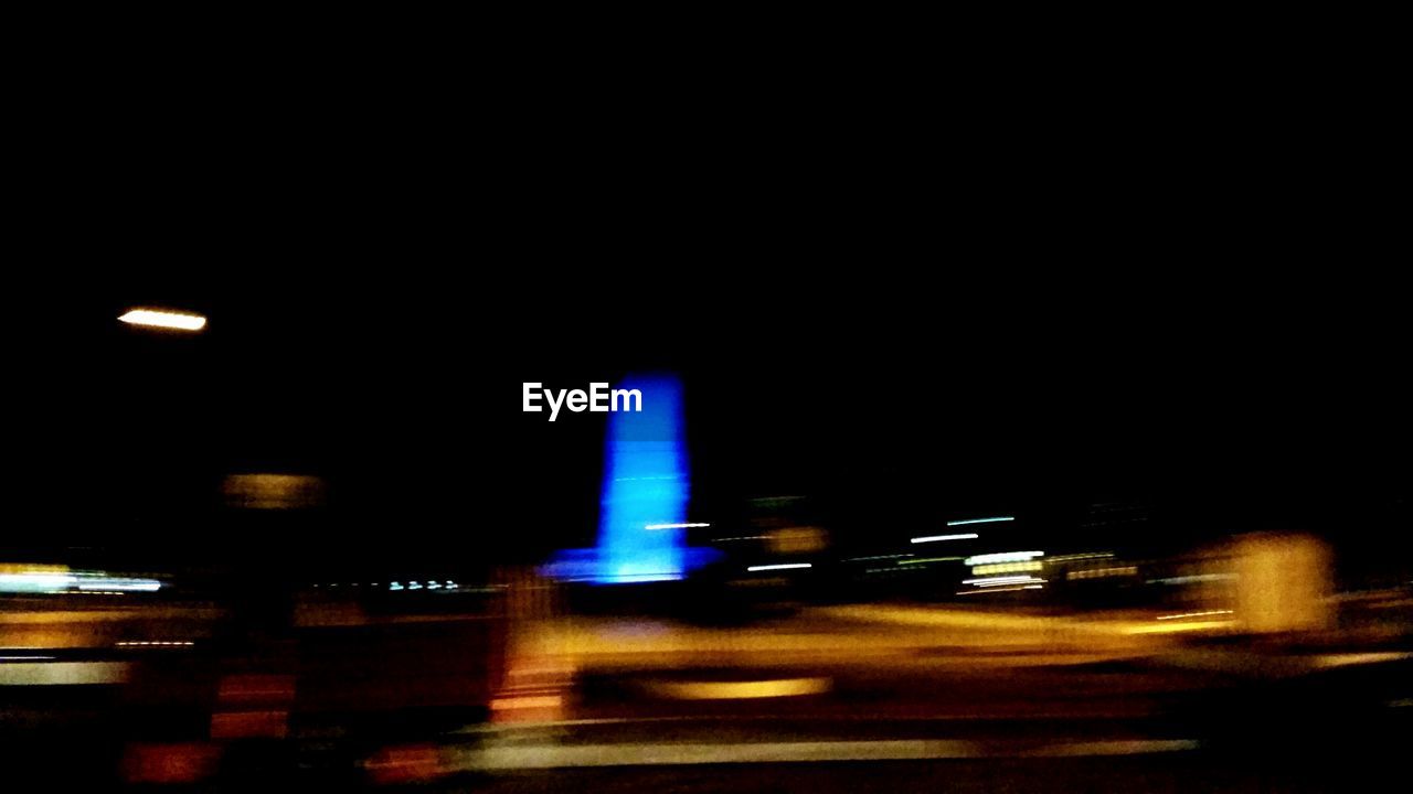 VIEW OF ILLUMINATED CITY AT NIGHT