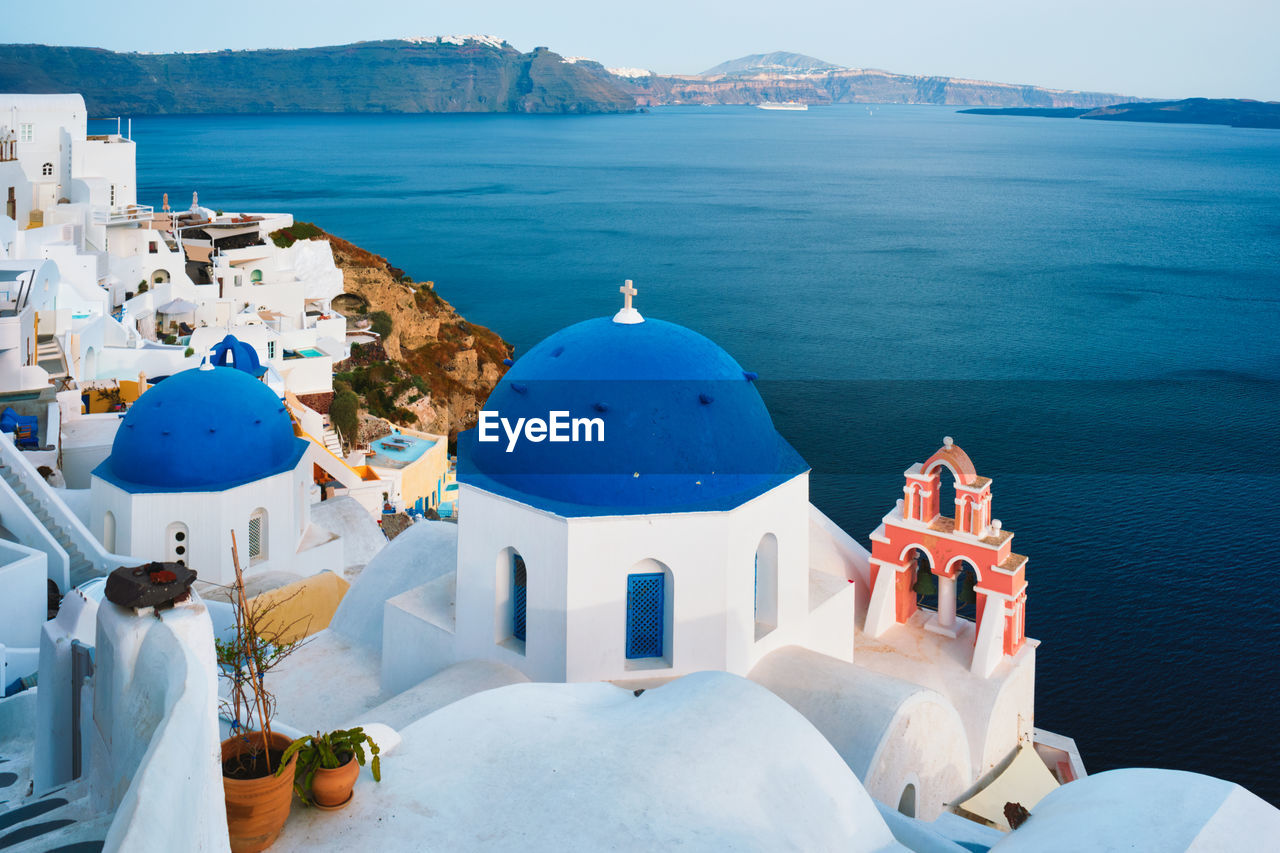 Famous view viewpoint of santorini oia village with blue dome of greek orthodox christian church