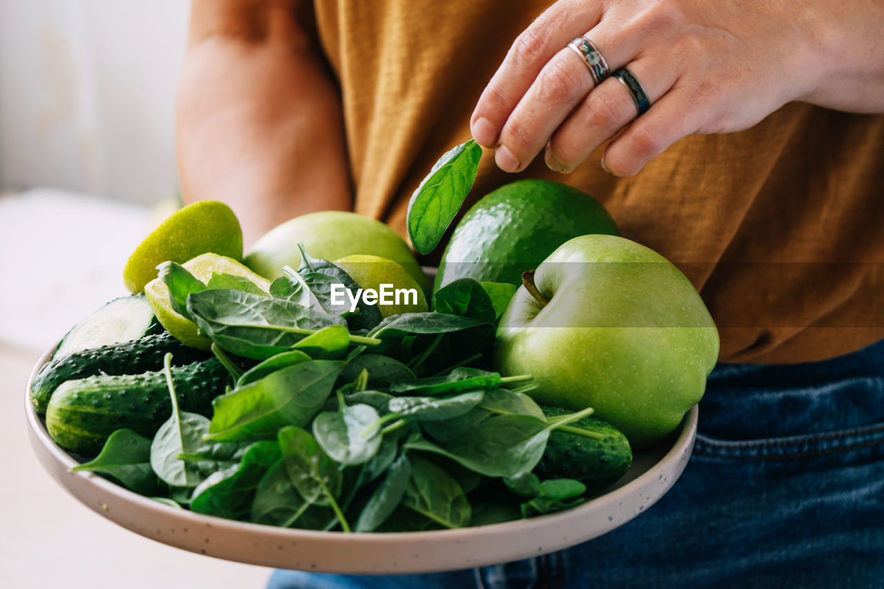 midsection of man holding salad