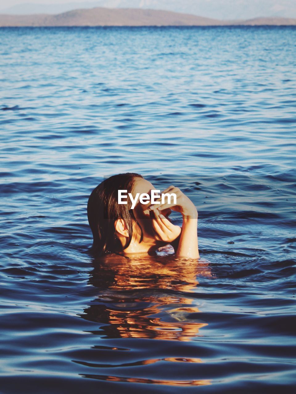 Young woman swimming in sea