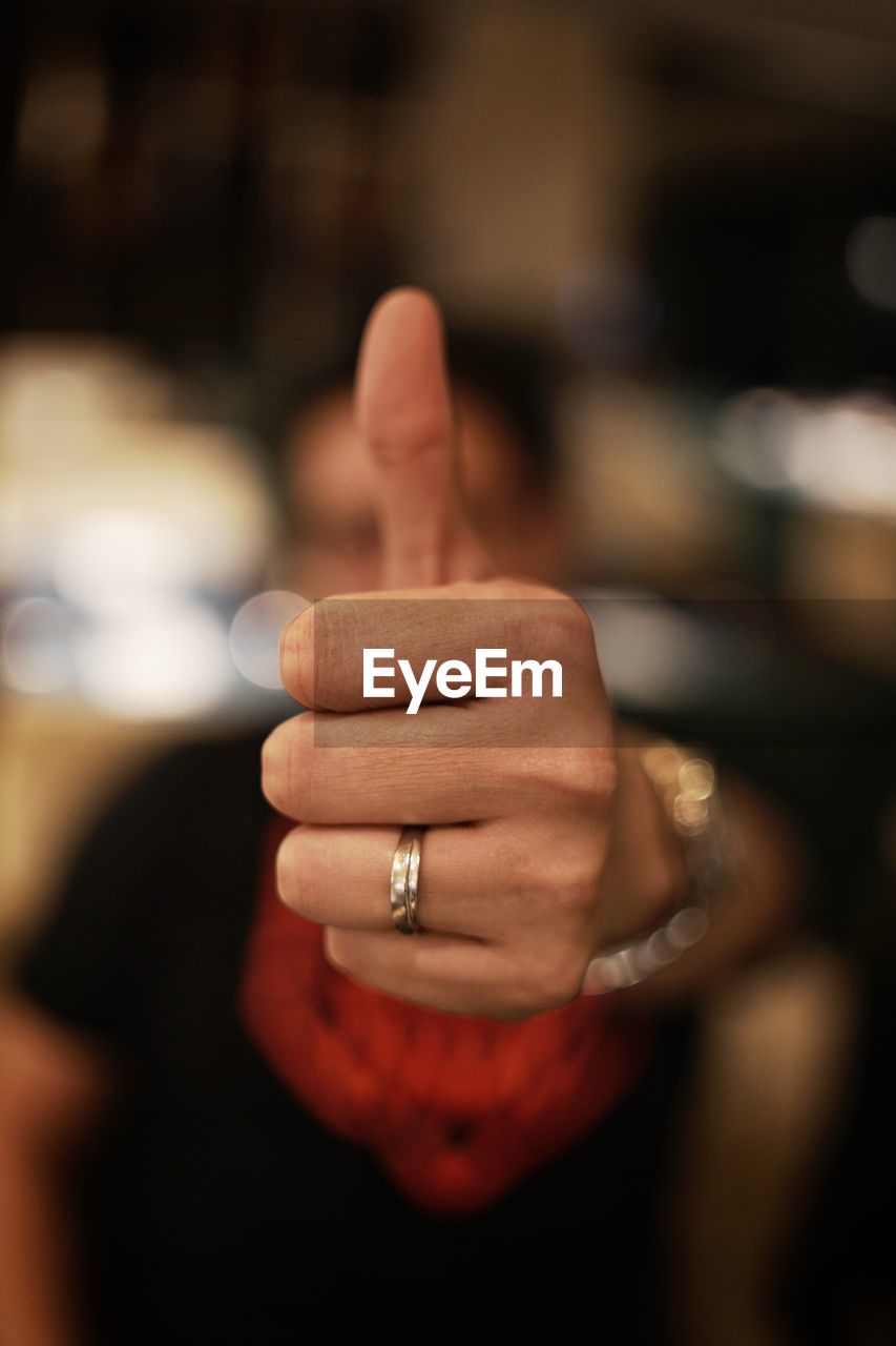 Close-up of man showing thumbs up sign 