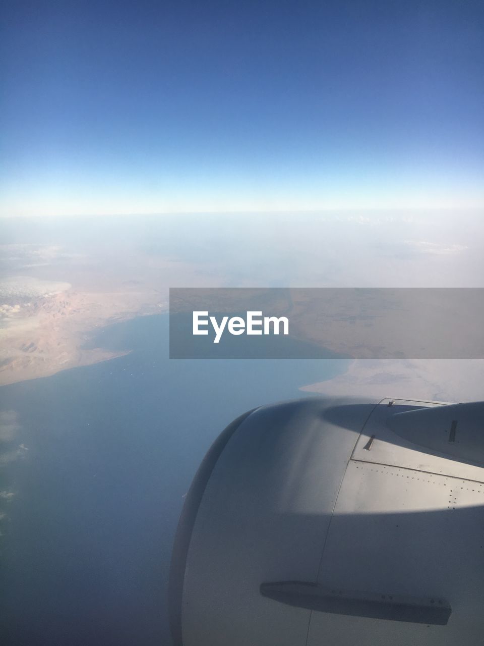 AERIAL VIEW OF AIRCRAFT WING OVER SEA