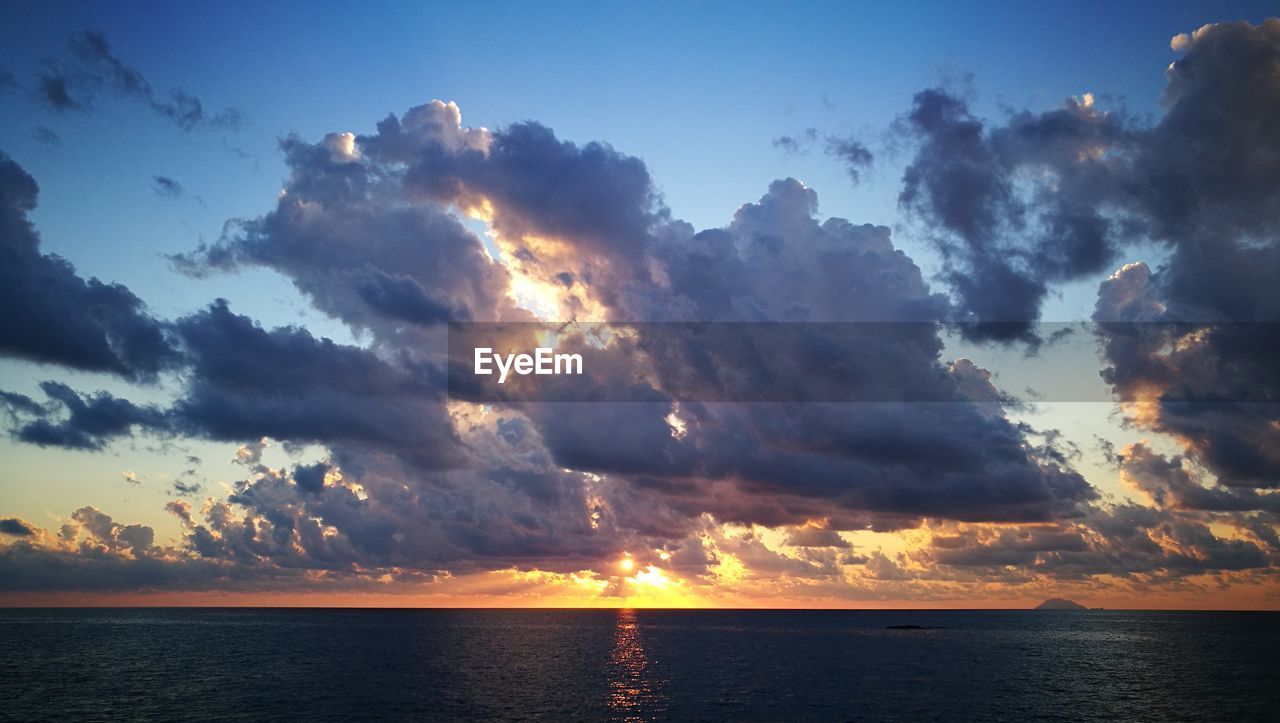 SCENIC VIEW OF SEA AGAINST SKY AT SUNSET