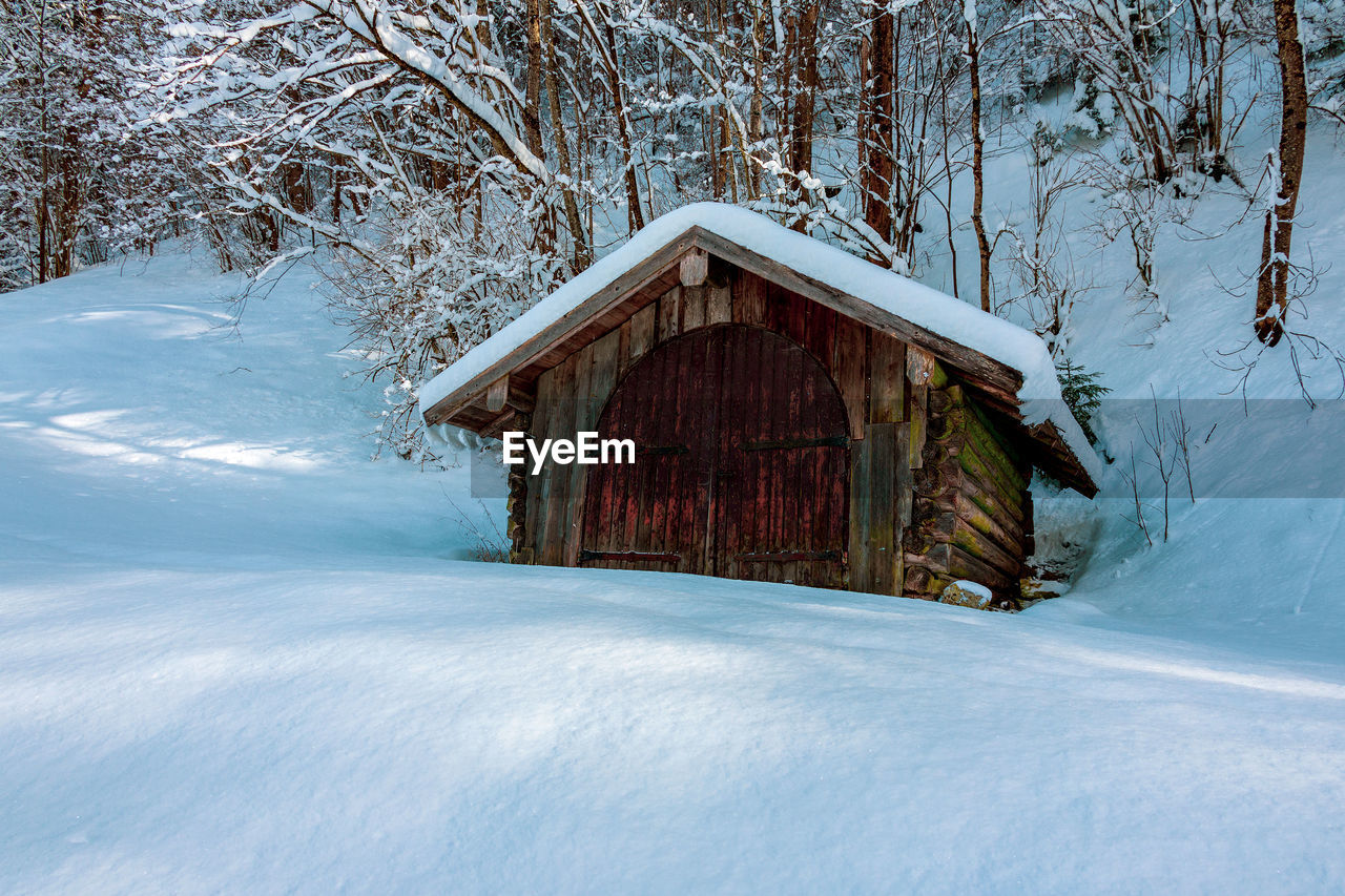 View of frozen house in winter