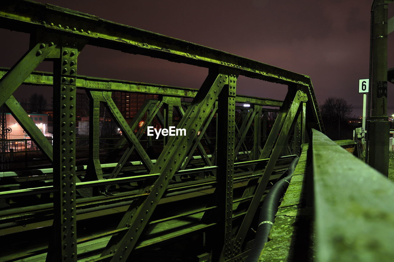 Illuminated bridge against sky at night