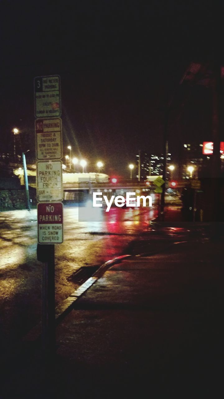 VIEW OF ILLUMINATED STREET LIGHTS AT NIGHT