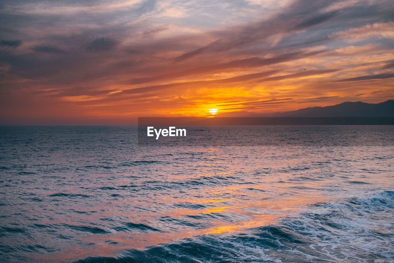 scenic view of sea at sunset