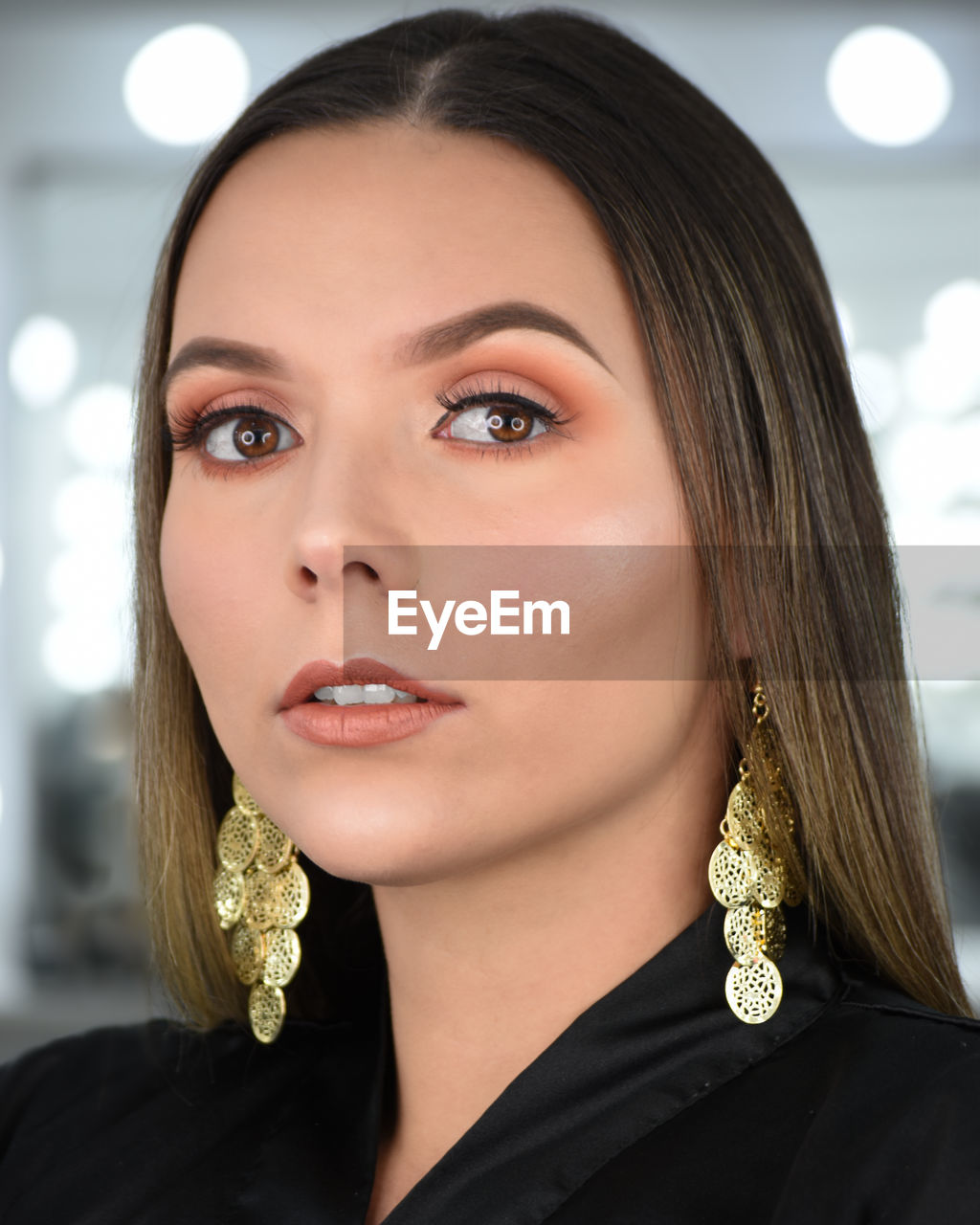 Close-up portrait of young woman wearing earrings