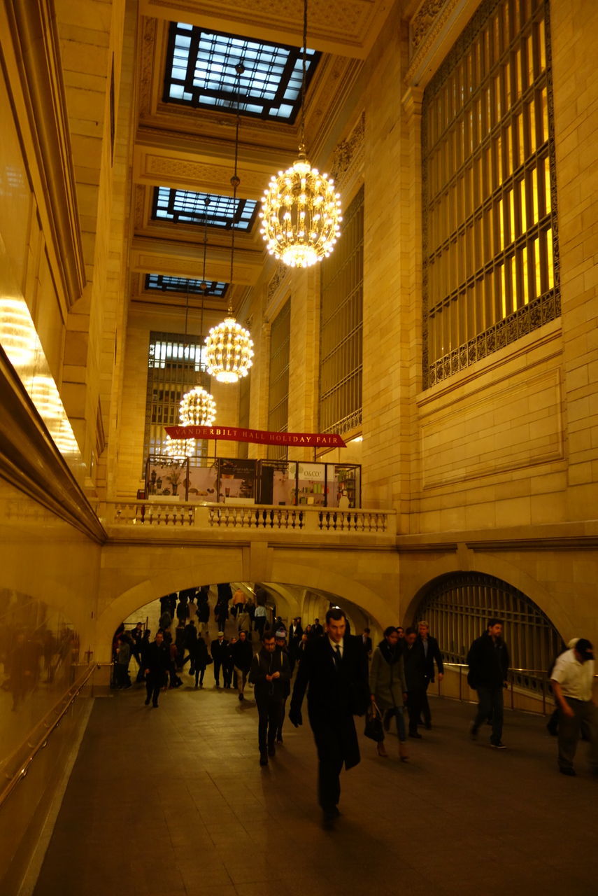 PEOPLE IN ILLUMINATED SUBWAY STATION