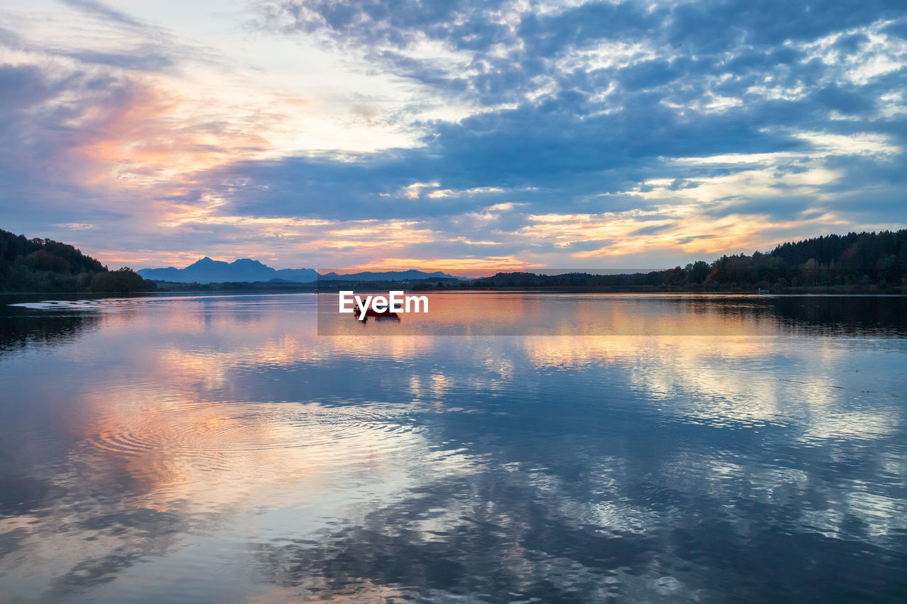 Scenic view of lake against sky during sunset