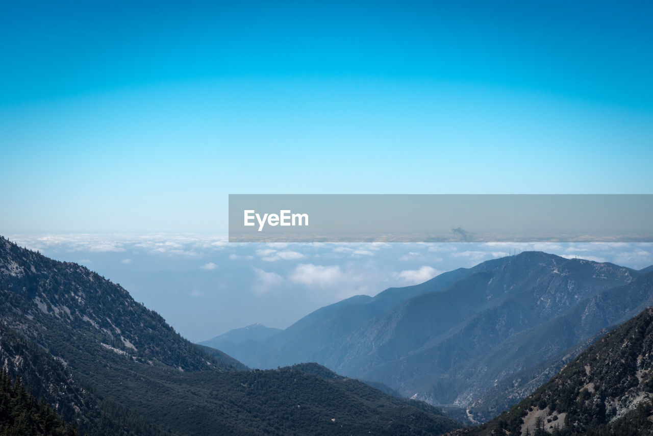 Scenic view of mountains against clear blue sky