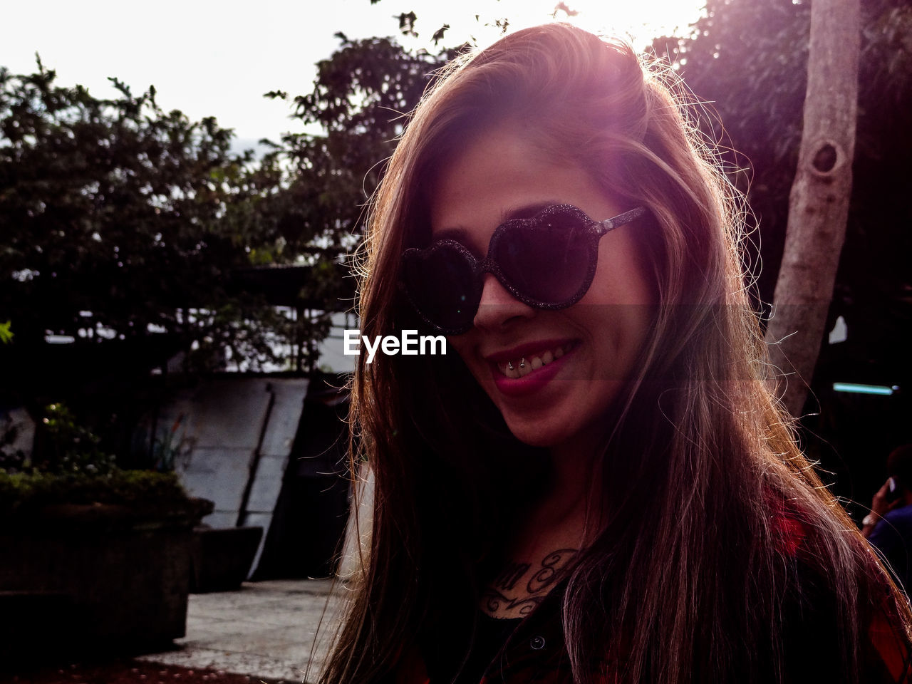 Smiling young woman wearing heart shaped eyeglasses