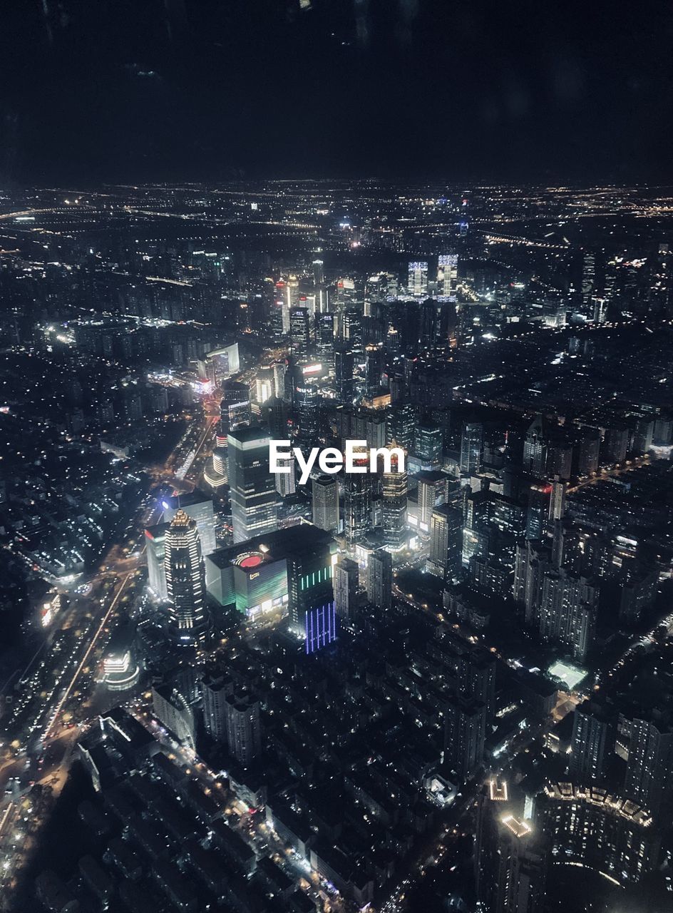 High angle view of illuminated city buildings at night