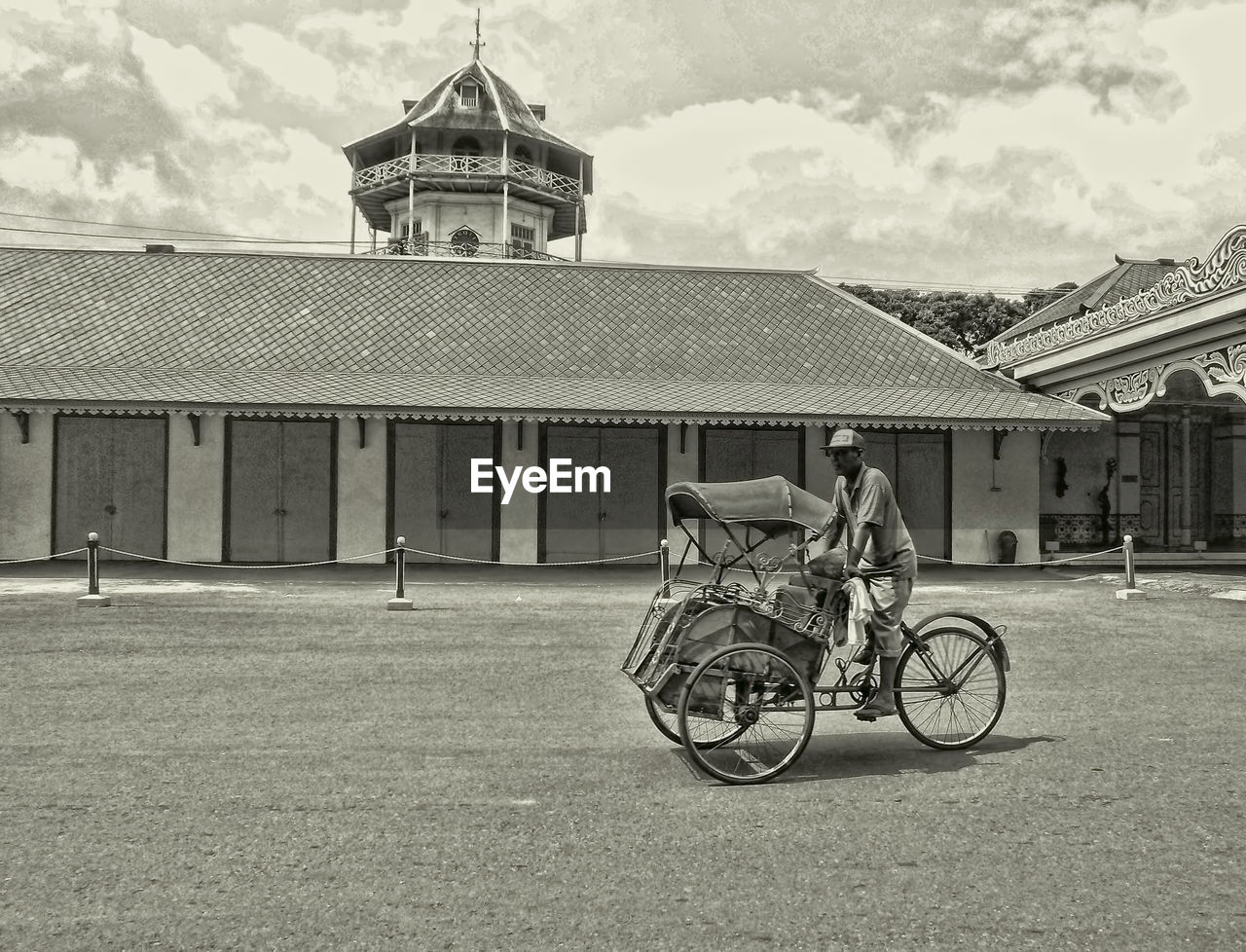 MAN WITH BICYCLE IN BACKGROUND