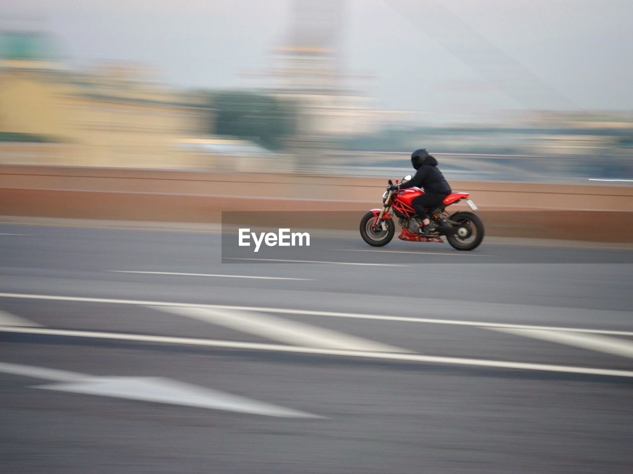 Person riding motorcycle on road