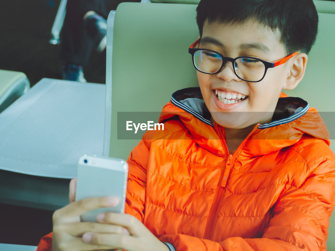 Smiling boy holding mobile phone