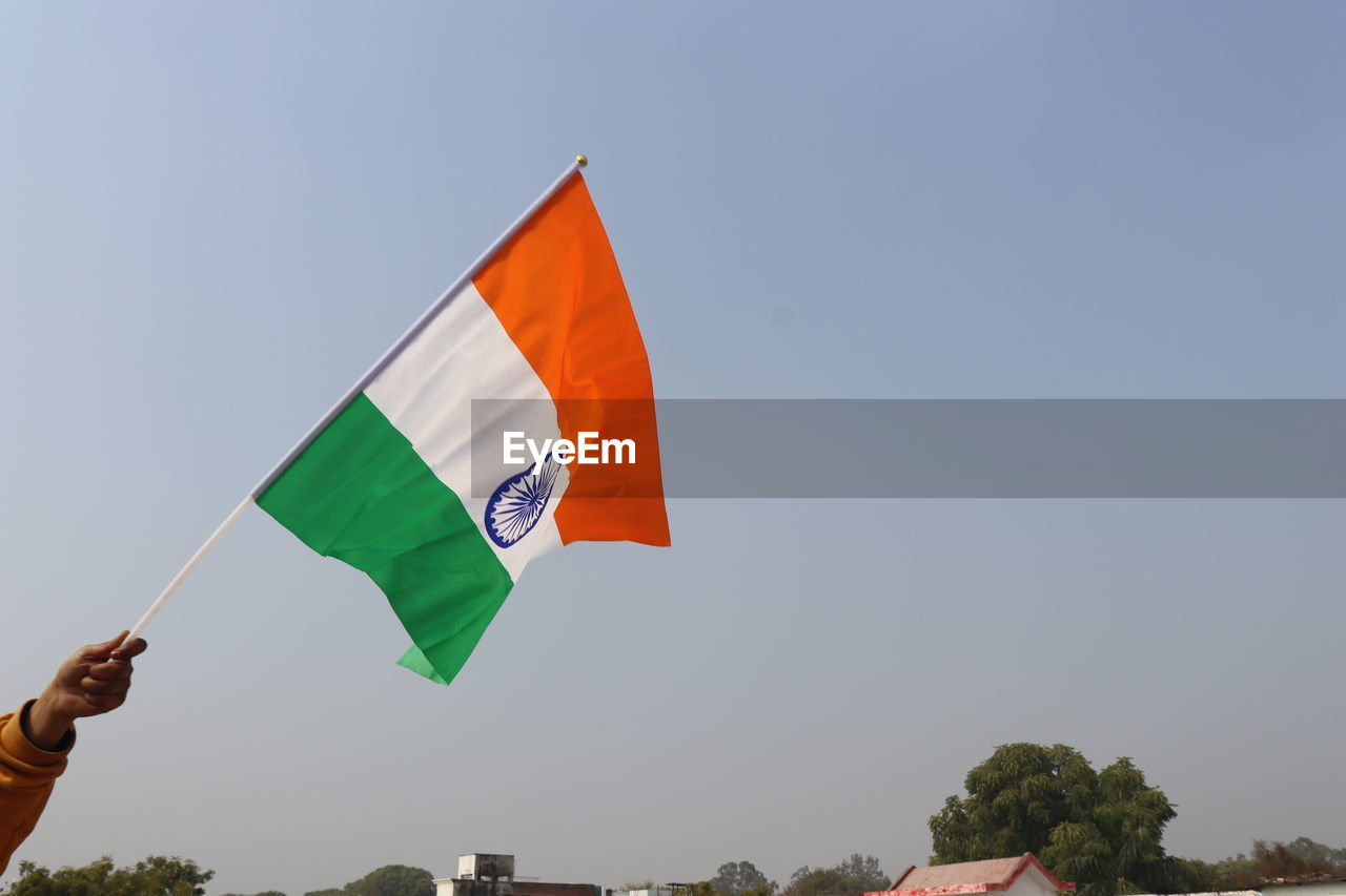 Low angle view of flag against clear sky