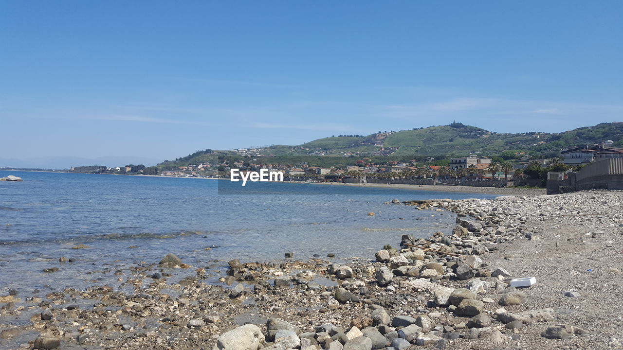 SCENIC VIEW OF SEA AGAINST BUILDINGS