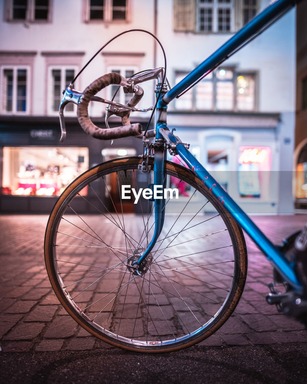 Close-up of bicycle parked on street against building