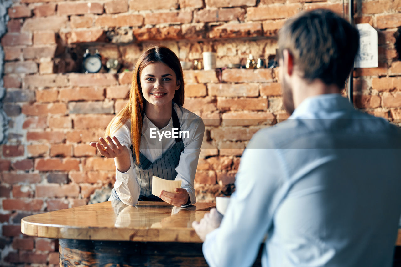 Rear view of couple sitting at table