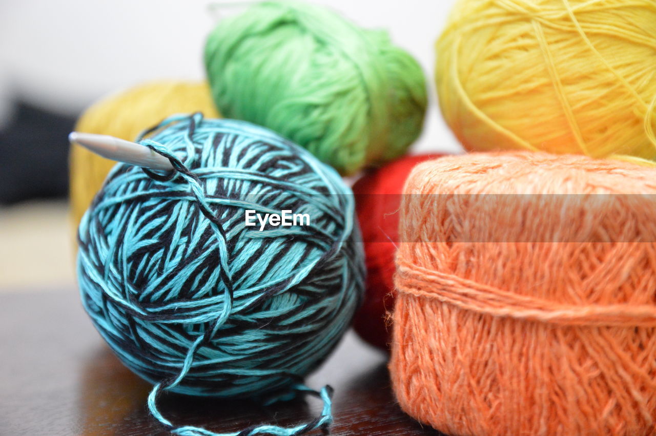 Close-up of multi colored wool balls on table