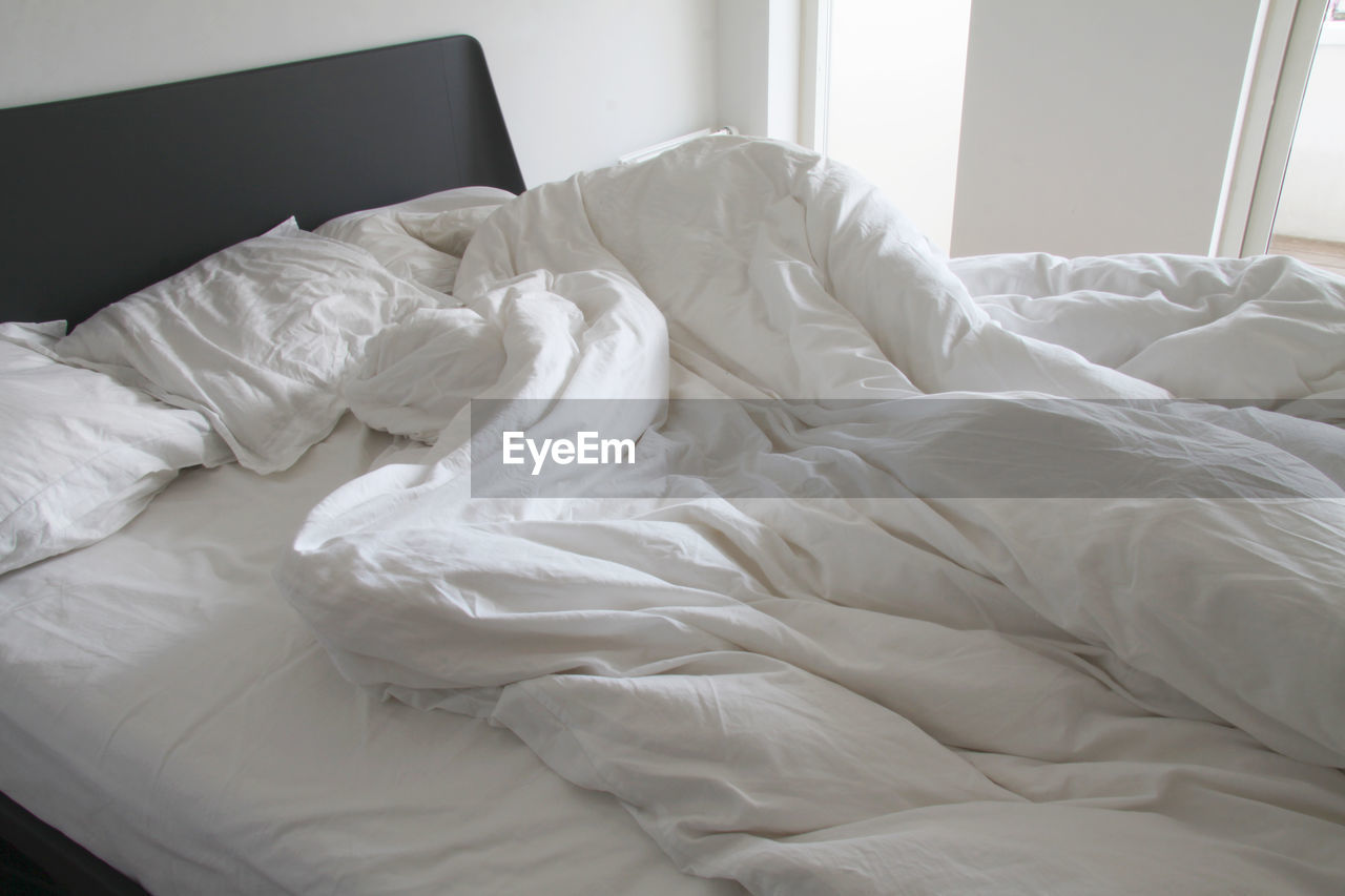 White blanket on bed at home