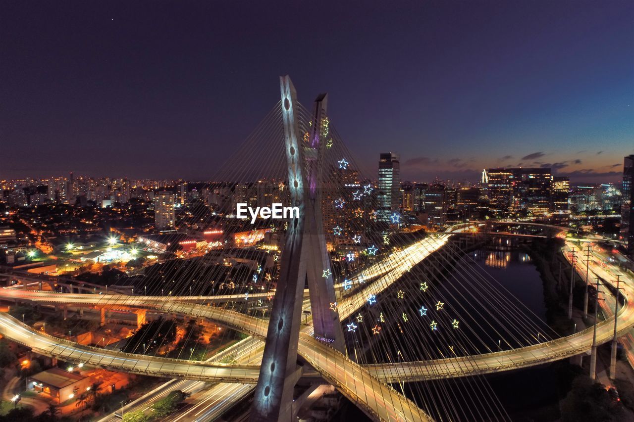 High angle view of illuminated buildings against sky at night