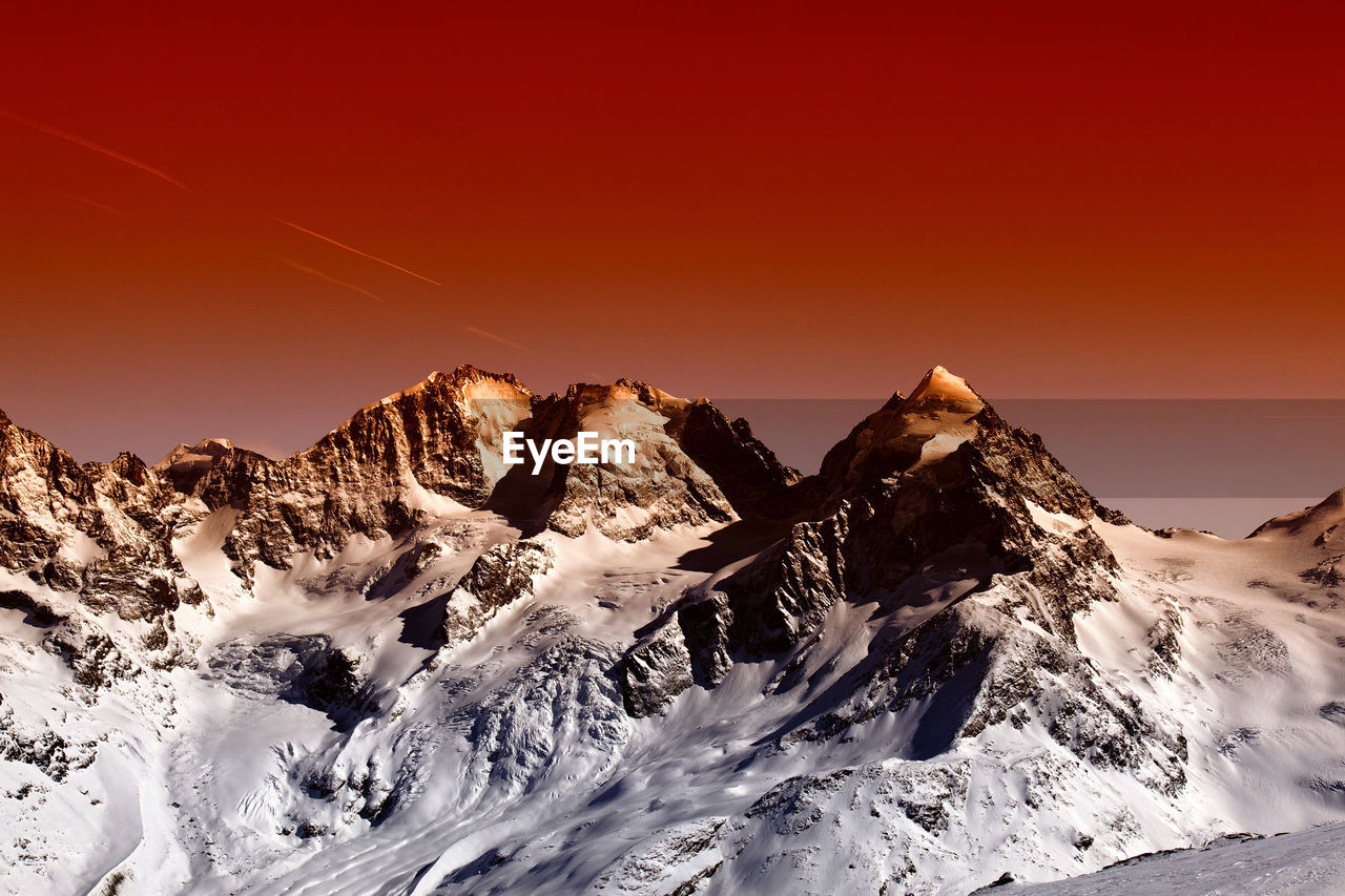 SNOWCAPPED MOUNTAINS AGAINST CLEAR SKY