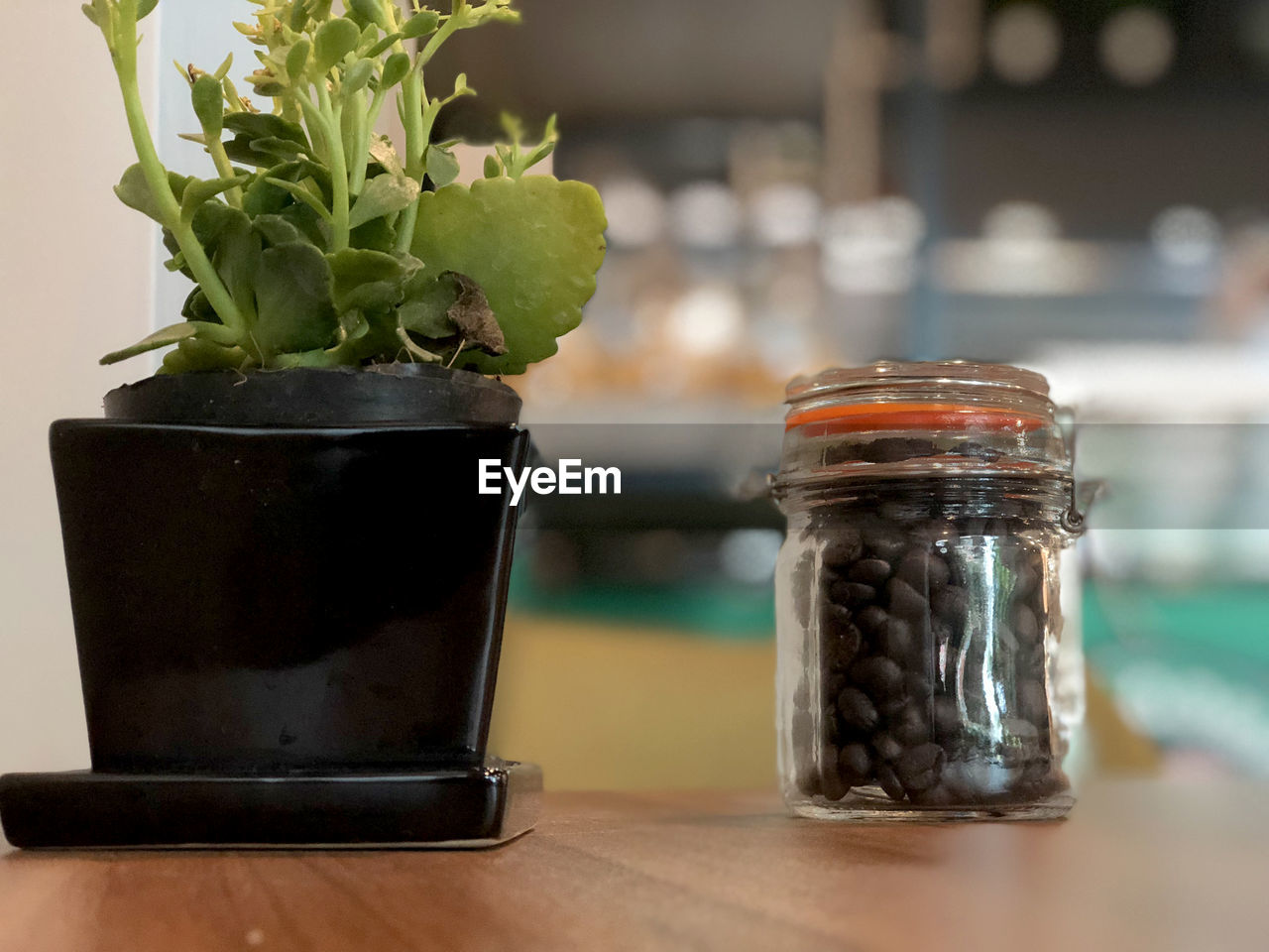 Close-up of coffee beans in glass jar on table