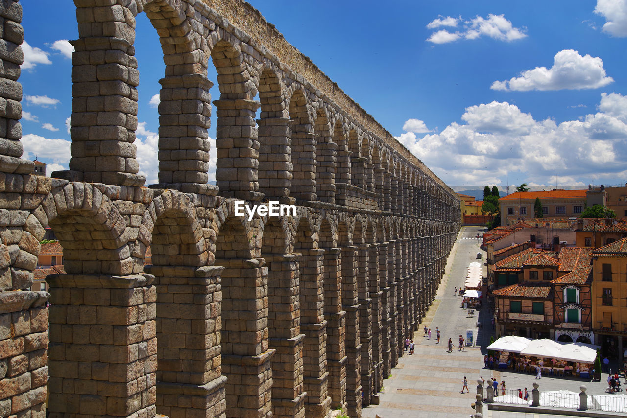 Aqueduct of segovia against sky in city