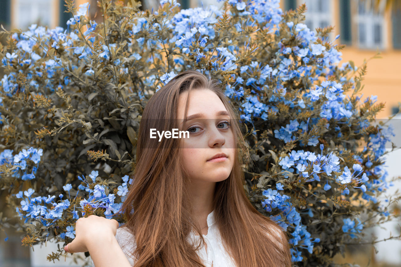 Portrait of young woman looking at camera