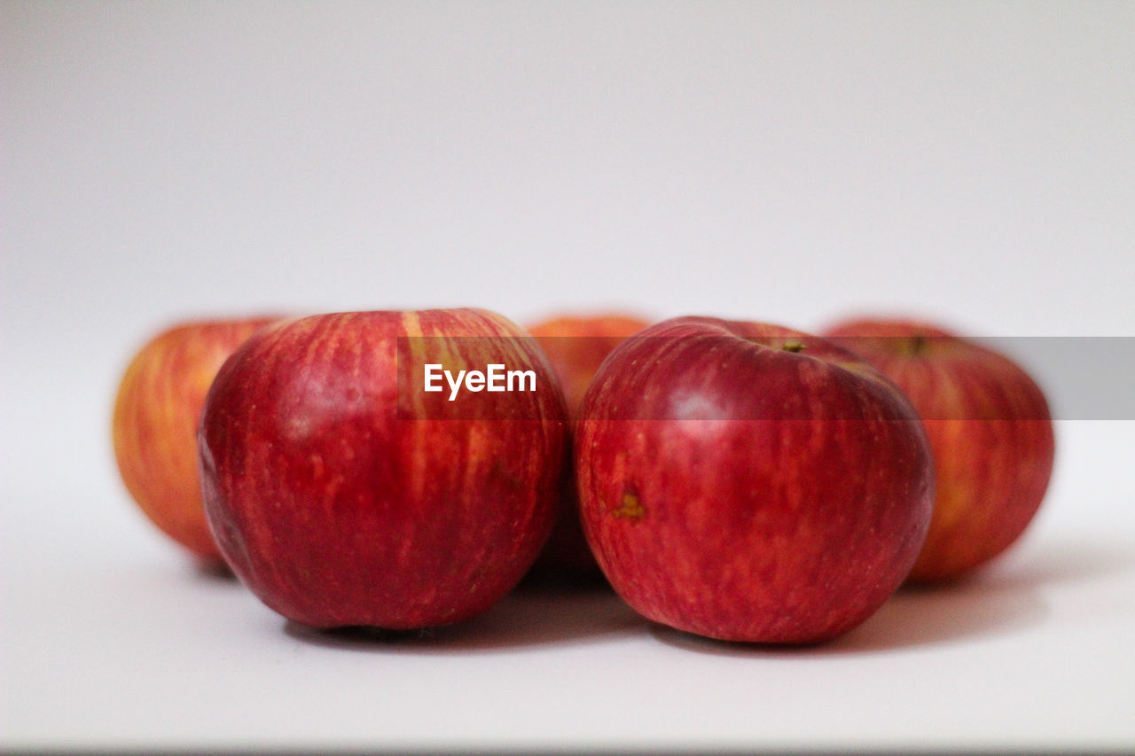 CLOSE-UP OF APPLES ON WHITE BACKGROUND