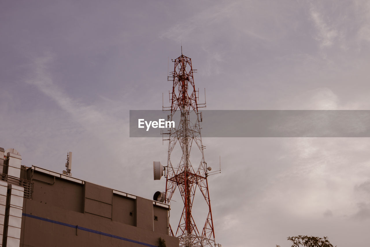 Low angle view of communications tower against sky