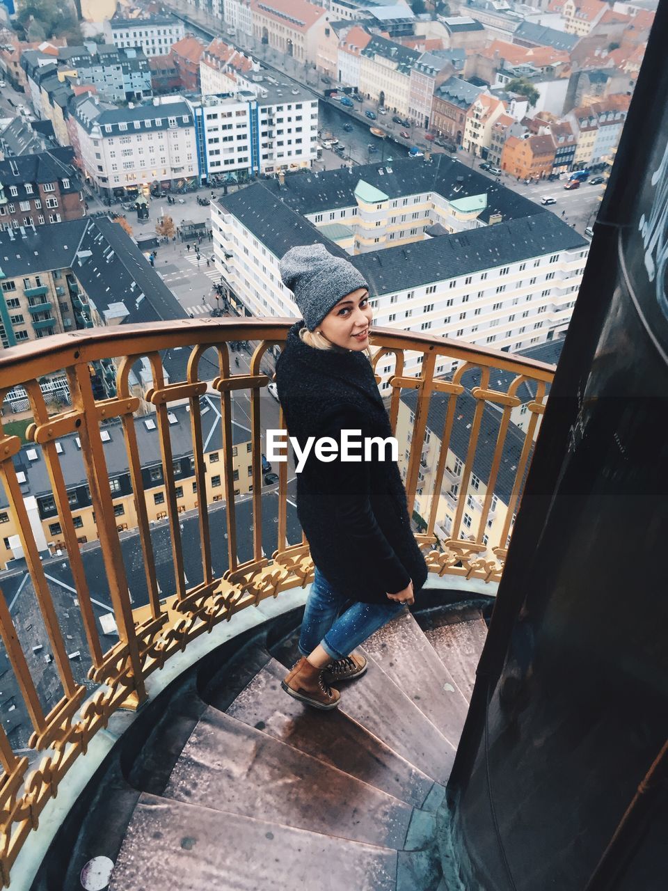 Woman on staircase above city