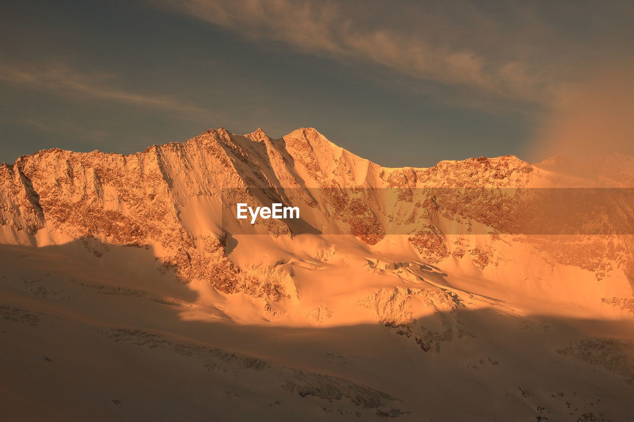 Scenic view of desert against sky during sunset