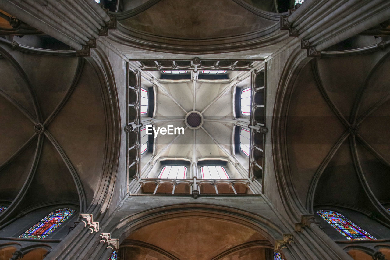 LOW ANGLE VIEW OF CEILING OF MOSQUE HANGING FROM CHURCH